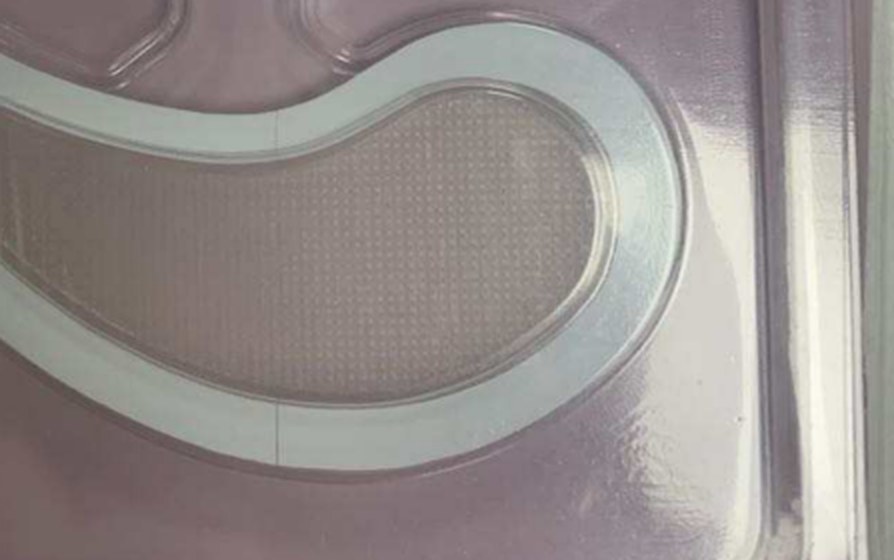 Dissolving microneedle array on a Yanse patch — close-up of the moulded cone grid